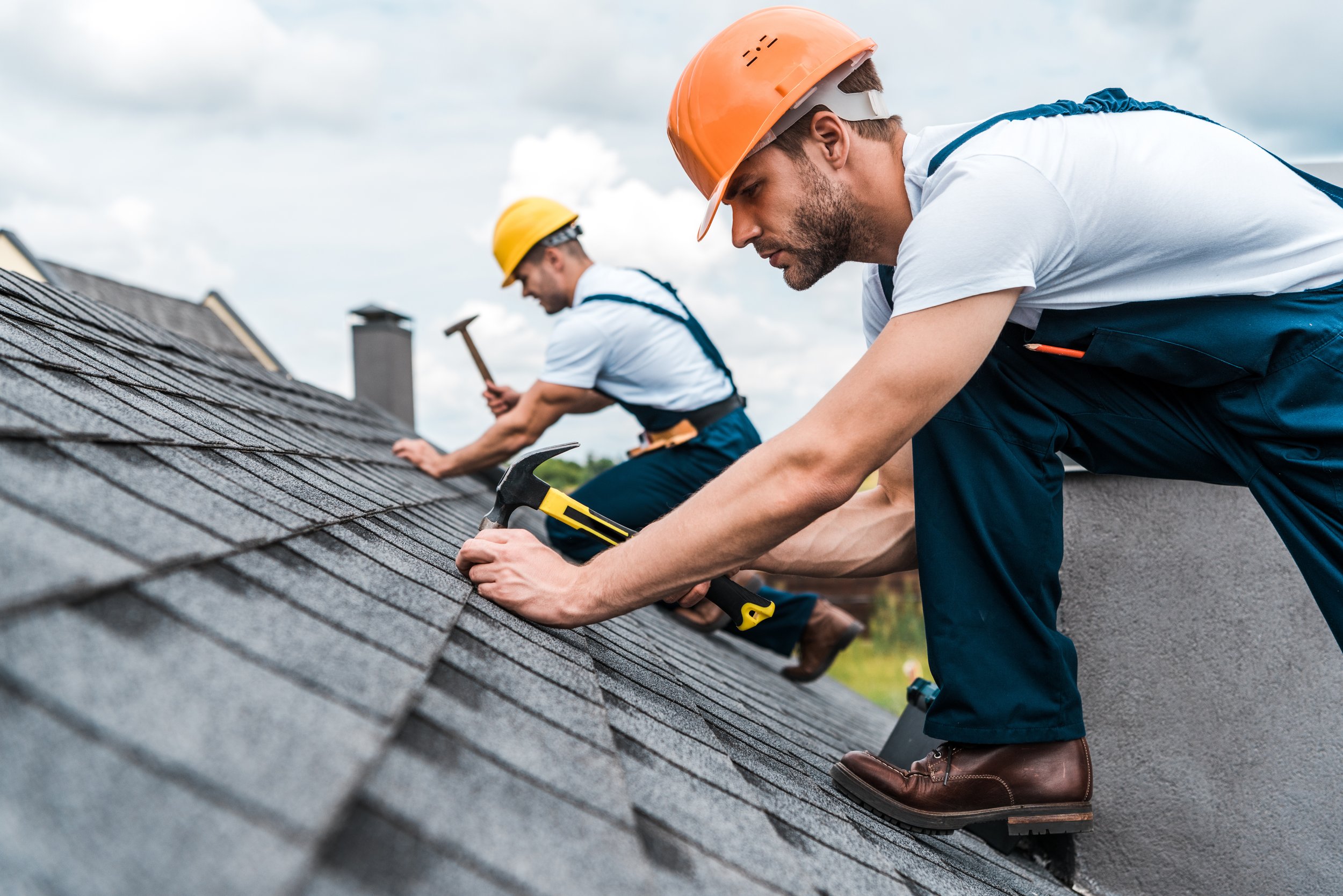 Helio GC roofers installing underlayment on a steep roof